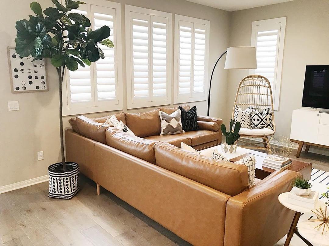 Warm living room with our Polywood shutters in New York.